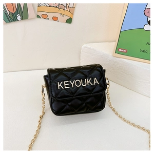 Close-up of quilted black mini crossbody bag with gold chain and metal brand logo