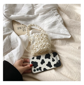 Detailed view of handmade pearl beaded mini bag featuring glossy beads and woven texture