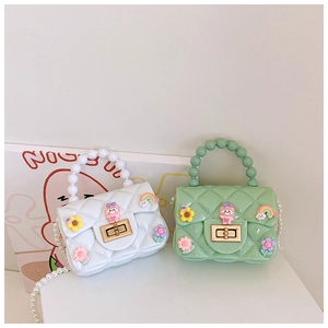 Detail of white and mint green jelly bags with pearl handles and cute 3D cartoon charms