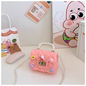 Detail of pink quilted kids crossbody bag with pearl handle and cartoon rabbit charms