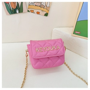 Detail of pink quilted PU leather mini crossbody bag with gold chain and metal logo
