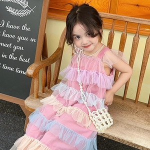 Cute girl's woven pearl mini crossbody bag paired with an elegant purple layered dress