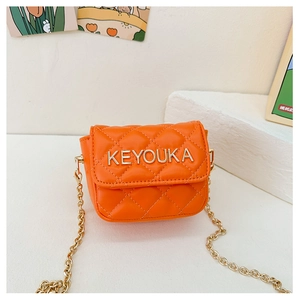 Detail of orange quilted PU leather mini crossbody bag with gold chain and silver logo