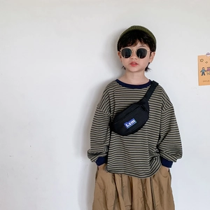 Child fashion outfit featuring a black crossbody chest bag and striped sweatshirt