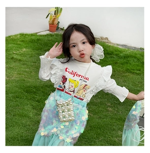 Detail of white ruffle long sleeve top and mermaid sequin skirt set for girls