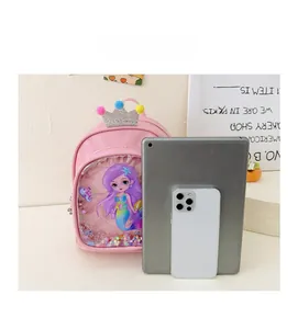 Size comparison of the pink mermaid backpack with a tablet and mobile phone