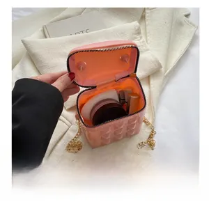 Detail view of pink quilted silicone mini bag showing interior capacity and gold chain