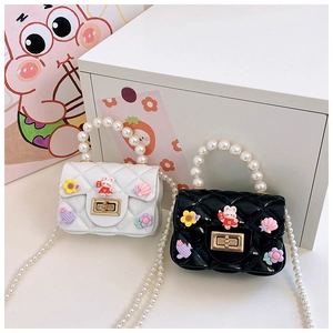 Detail of mini quilted jelly bags with elegant pearl handles and cute rabbit charms
