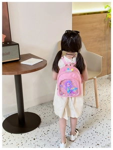 Close-up of pink girls backpack with mermaid print and sparkly sequin front pocket