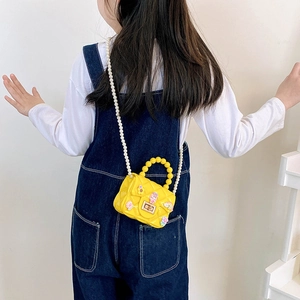 Cute yellow silicone mini bag for girls with cartoon charms and pearl chain strap