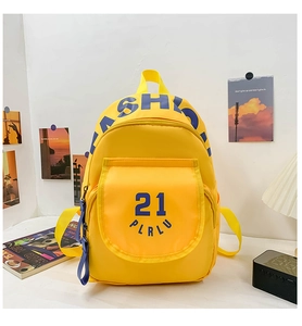 Detail of bright yellow canvas backpack with blue Fashion lettering and number 21 design