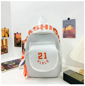 Detail showing white canvas backpack with orange fashion letter print and contrast tag