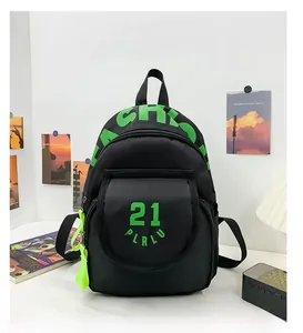 Detail of black canvas kindergarten backpack with neon green lettering and side mesh pocket