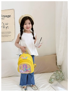 Detail of yellow toddler backpack with mermaid pocket and sequin crown decoration