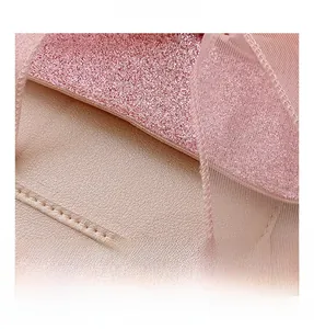 Detail of pink glitter fabric and faux leather with soft mesh and pearl accents