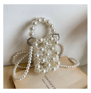 Detail of hand-beaded mini pearl crossbody bag for girls with elegant pearl chain strap