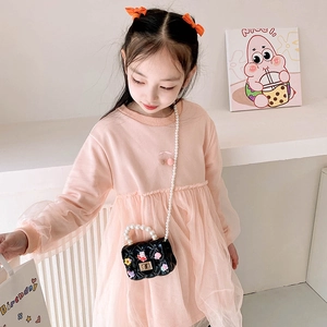 Pink tulle dress with cherry embroidery paired with a rabbit pearl handle handbag
