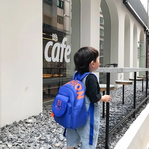 Kids fashion canvas backpack in royal blue with orange lettering for school use