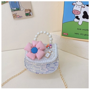 Détail d'un mini sac enfant à paillettes avec fleur rose et anse en perles