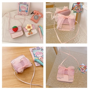 Detail of girls mini PU crossbody bag with mesh bow, pearls and strawberry ornaments