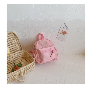 Detailed close-up of pink mini backpack with durable nylon fabric and Girl Cats logo
