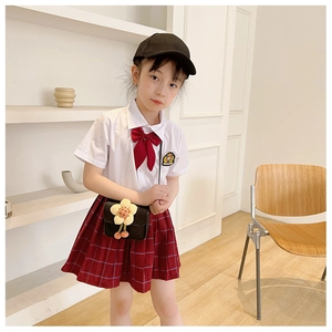 Detail of a black PU leather crossbody bag with a 3D yellow flower on a girl's school outfit
