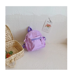 Detail view of purple kids backpack with embossed Girl Cats text on the front pocket