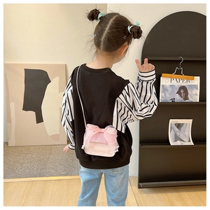 Pink toddler crossbody bag featuring a large mesh bow and sparkling glitter details