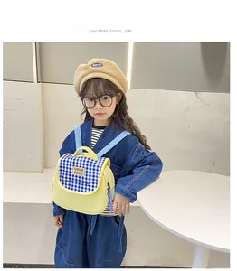 Dettaglio dello zaino giallo a scacchi per bambina con spalline blu regolabili