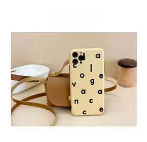 Size comparison of a brown leather crossbody bag and a patterned phone case