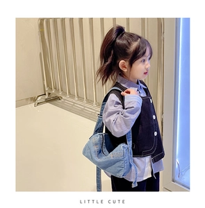 Detailed side view of a child wearing a casual blue denim crossbody bag with adjustable strap
