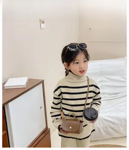 Miniature brown leather crossbody bag for girls with adjustable strap and gold buckle detail