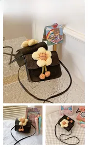 Detail of black glitter PU mini crossbody bag with large yellow plush flower decoration