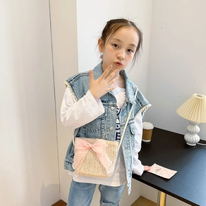 Kids woven straw crossbody bag with large pink tulle bow and pearl charm details