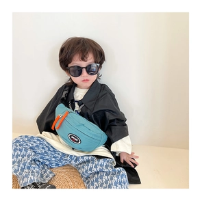 Détail du sac de poitrine en toile bleue pour enfant avec fermeture éclair orange