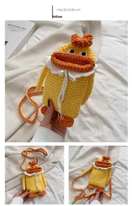 Close-up of handmade knitted duck crossbody bag with yellow yarn and orange beak details