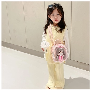 Detailed view of a pink sequin backpack featuring a 3D doll on a young girl model