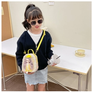 Detail of girls' crossbody bag with pearl texture, 3D doll ornament and yellow strap