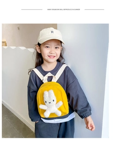 Detail of yellow canvas kids backpack featuring a plush 3D bunny and adjustable straps