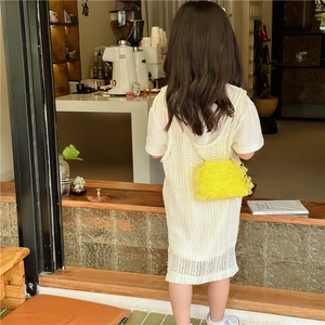 Süßes Mädchenkleid mit gelber gestufter Netztasche in gemütlicher Café-Atmosphäre