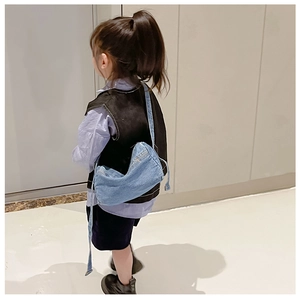Kids denim crossbody bag in blue, shown on a child model for casual fashion look