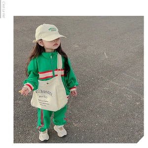 Detail showing high-quality green canvas crossbody bag for kids with letter print