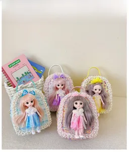 Detail view of tweed mini bags with pearl trim and doll charms in four pastel colors