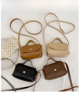 Flat lay detail of four mini PU leather crossbody bags in yellow, beige, black, and brown