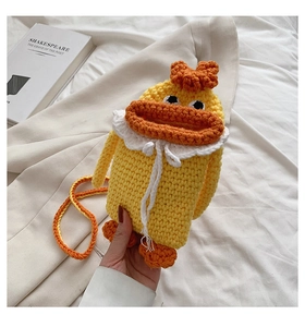 Detailed close-up of a handmade crochet duck crossbody bag with cute orange beak