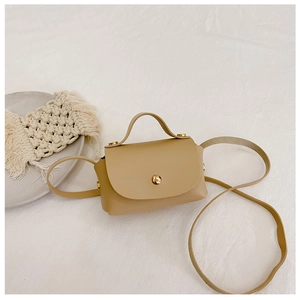 Close-up of khaki mini faux leather crossbody bag with golden buckle and textured detail