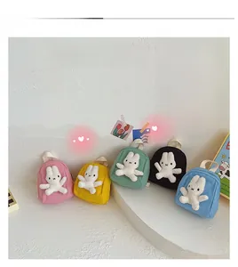 Detailed display of colorful canvas mini backpacks featuring white plush rabbit accents