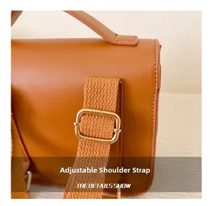 Detailed close-up of adjustable shoulder strap with gold metal buckle on PU leather bag