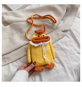 Detailed knit texture of handmade yellow duck crochet crossbody bag with lace detail