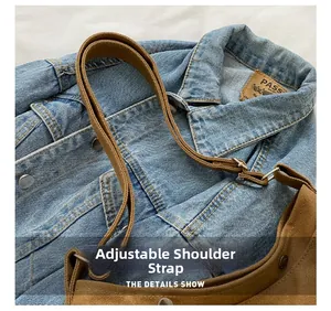 Detail of adjustable fabric shoulder strap with metal buckle on brown canvas bag